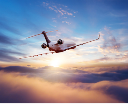 Airplane wing at sunrise viewed from a premium cabin