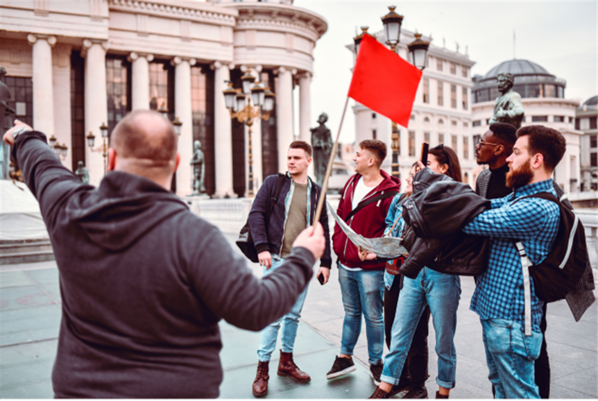 Small group with guide walking through historic city