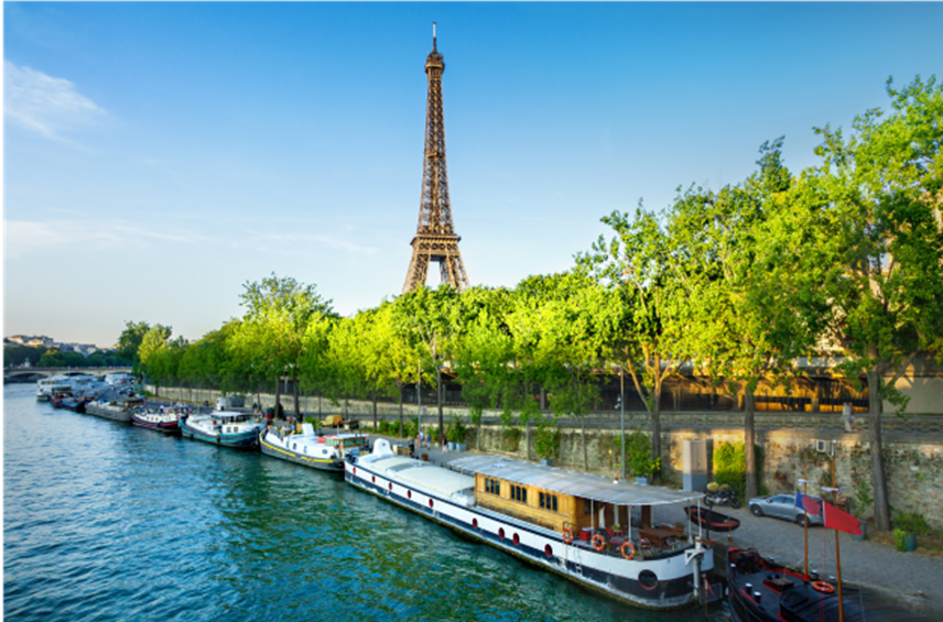 Elegant river cruise ship sailing past a European town